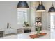 Bright kitchen boasts an island with bar seating, stainless appliances, and stylish pendant lighting at 385 Rowes Cir, Alpharetta, GA 30009