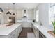 Open-concept kitchen with gray cabinetry, stainless steel appliances, and hardwood floors at 385 Rowes Cir, Alpharetta, GA 30009