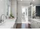 Bright kitchen featuring white cabinets, light countertops, and stainless steel faucet at 385 Rowes Cir, Alpharetta, GA 30009