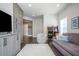 Spacious entertainment room with ample seating, modern television, and arcade games for fun gatherings at 385 Rowes Cir, Alpharetta, GA 30009