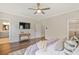 Spacious main bedroom featuring wood flooring, closet, and a decorative ceiling fan at 385 Rowes Cir, Alpharetta, GA 30009