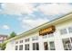 Exterior of 'Chiringa' restaurant with white walls, large windows, and a clear blue sky above at 385 Rowes Cir, Alpharetta, GA 30009