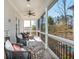 Relaxing screened-in porch with comfortable seating and a view of the backyard at 385 Rowes Cir, Alpharetta, GA 30009
