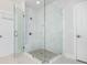 Modern glass shower with a pebble floor and a built in bench at 385 Rowes Cir, Alpharetta, GA 30009