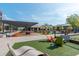 Vibrant town green featuring colorful chairs, lounge seating, bocce ball, and artificial turf at 385 Rowes Cir, Alpharetta, GA 30009