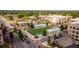 Scenic view of a town square with a green lawn, surrounding businesses, and street traffic at 385 Rowes Cir, Alpharetta, GA 30009