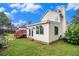 View of the home's rear exterior from the backyard with a covered patio at 6177 Idlewood Cir, Lithonia, GA 30038