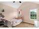 A cozy bedroom with a sloped ceiling and natural light from two windows at 6177 Idlewood Cir, Lithonia, GA 30038