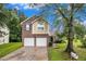 Charming two-story home featuring a brick and siding exterior, attached two-car garage, and well-maintained front lawn at 6177 Idlewood Cir, Lithonia, GA 30038