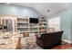 Cozy living room with hardwood floors and built-in shelving at 6177 Idlewood Cir, Lithonia, GA 30038