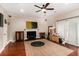 Spacious living room boasts hardwood floors, fireplace, and sliding glass doors to the backyard at 6177 Idlewood Cir, Lithonia, GA 30038