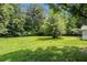 Expansive backyard featuring lush green grass and mature trees, perfect for outdoor activities and enjoying nature at 1186 Eastview Ne Rd, Conyers, GA 30012