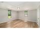 This bedroom features wood-look floors and ample natural light from two windows at 1186 Eastview Ne Rd, Conyers, GA 30012