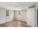 View of bedroom with wood-look floors, two windows, and white walls at 1186 Eastview Ne Rd, Conyers, GA 30012