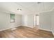 View of bedroom with wood-look floors, white walls, and natural light at 1186 Eastview Ne Rd, Conyers, GA 30012