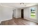 Bedroom with wood-look flooring, neutral paint, and ample natural light at 1186 Eastview Ne Rd, Conyers, GA 30012
