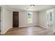 Bedroom with wood-look flooring, neutral paint, and ample natural light at 1186 Eastview Ne Rd, Conyers, GA 30012