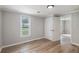 Bedroom featuring wood-look floors, white walls, and a window with natural light at 1186 Eastview Ne Rd, Conyers, GA 30012