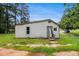 Rear exterior showing siding, windows, and access door at 1186 Eastview Ne Rd, Conyers, GA 30012