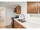 Close-up of kitchen area with wood cabinets and stainless steel appliances at 1186 Eastview Ne Rd, Conyers, GA 30012