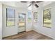 Bright sunroom with wood-look floors and multiple windows at 1186 Eastview Ne Rd, Conyers, GA 30012
