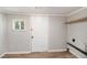 Utility room with a window, white door, shelf, and vinyl floors at 1186 Eastview Ne Rd, Conyers, GA 30012