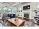 Cozy living room with a fireplace, built-in shelving, and access to the outdoor patio at 2686 Oak Leaf Se Pl, Atlanta, GA 30316