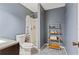 Updated bathroom featuring a tiled floor, shower, toilet, and storage rack with fresh towels at 2839 Orion Dr, Decatur, GA 30033