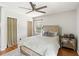 This bedroom offers a tufted headboard, ceiling fan, and a mirrored bedside table for a touch of elegance at 2839 Orion Dr, Decatur, GA 30033