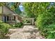 Long driveway to home featuring a covered carport surrounded by green foliage at 2839 Orion Dr, Decatur, GA 30033