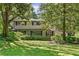 Traditional home with large trees, lush green grass, and manicured shrubs in a quiet neighborhood at 2839 Orion Dr, Decatur, GA 30033