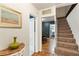 Hallway showcasing hardwood floors, adjacent dining area, and carpeted stairs at 2839 Orion Dr, Decatur, GA 30033