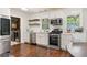 Bright white kitchen with stainless steel appliances, subway tile backsplash and dark hardwood floors at 2839 Orion Dr, Decatur, GA 30033