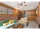 Living room with paneled walls, brick accents, and an adjoining laundry room at 2839 Orion Dr, Decatur, GA 30033