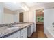 Bathroom featuring a granite countertop, double sinks, and white cabinetry that provides a luxurious feel at 2894 Regent Walk Dr, Duluth, GA 30096