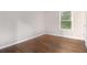 A brightly lit bedroom with vinyl flooring, and a door in the corner at 2894 Regent Walk Dr, Duluth, GA 30096