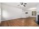 Bright living space with hardwood floors, fireplace, open layout, and a view of the kitchen at 2894 Regent Walk Dr, Duluth, GA 30096