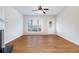 Open living space with hardwood floors, neutral walls, and large window with natural light at 2894 Regent Walk Dr, Duluth, GA 30096