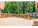 Backyard wooden deck with shed and privacy fence beyond, all surrounded by mature trees at 2985 Westbury Dr, Decatur, GA 30033