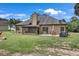 Spacious backyard with a screened in porch, patio and mature trees at 3262 Beech Hollow Ct, Loganville, GA 30052