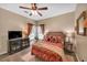 Cozy bedroom with a ceiling fan, TV, warm lighting and a large window at 3262 Beech Hollow Ct, Loganville, GA 30052