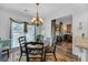 Sunlit breakfast nook with a round table and chairs, adjacent to the kitchen and living area at 3262 Beech Hollow Ct, Loganville, GA 30052