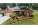 Charming single-story home with beautiful landscaping, featuring vibrant flowers and a well-maintained lawn at 3262 Beech Hollow Ct, Loganville, GA 30052