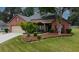 Charming brick home with manicured front yard and mature trees at 3262 Beech Hollow Ct, Loganville, GA 30052