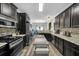 Modern kitchen featuring granite countertops, stainless steel appliances, and dark wood cabinets at 3262 Beech Hollow Ct, Loganville, GA 30052
