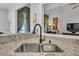 Close-up of the kitchen sink featuring a granite countertop and stainless steel faucet at 3262 Beech Hollow Ct, Loganville, GA 30052