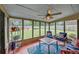 Bright sunroom with large windows, seating, and views of the fenced backyard at 3262 Beech Hollow Ct, Loganville, GA 30052