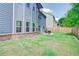 Grassy backyard with a small stone patio and dark metal furniture at 4824 Sultana Sw Way, Atlanta, GA 30331