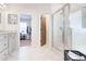 Bright, modern bathroom featuring white marble flooring and a glass-enclosed shower at 4824 Sultana Sw Way, Atlanta, GA 30331