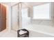 Bright bathroom features a soaking tub, glass enclosed shower, and stylish tile at 4824 Sultana Sw Way, Atlanta, GA 30331